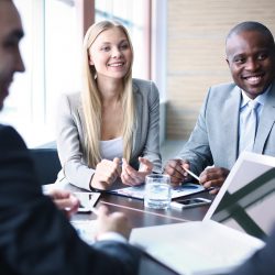 Image of business people listening and talking to their colleague at meeting