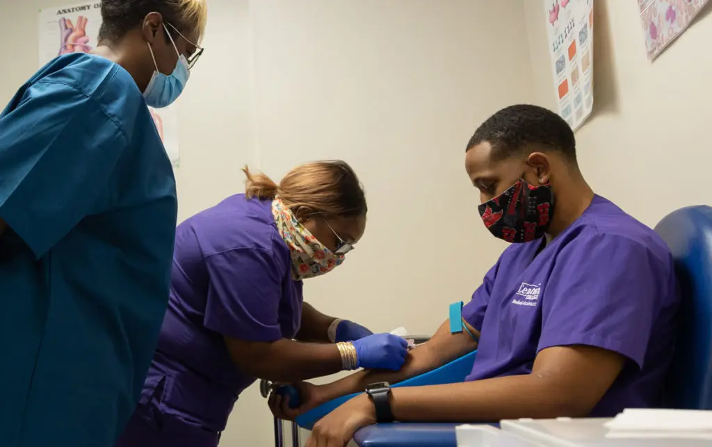 Medical assisting student practicing phlebotomy