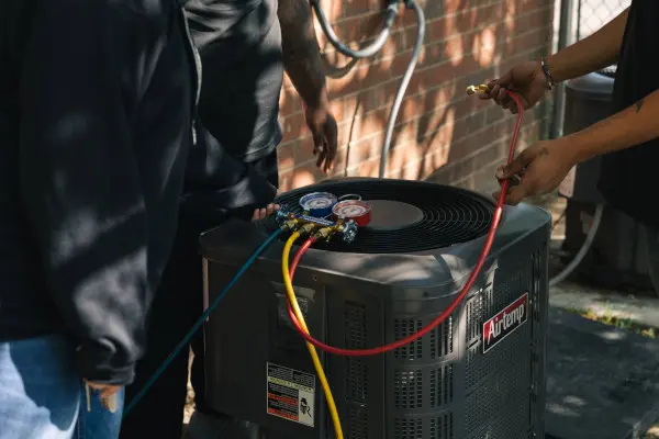 An air conditioner with HVAC maintenance equipment attached to it