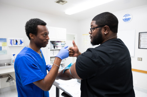 A student in the medical assisting program at Centura College practices administering injections.