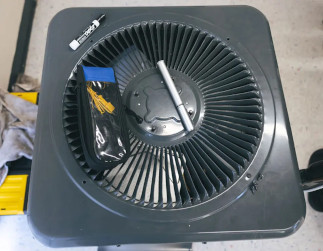 Top view of an air conditioner with markers and tools sitting on it