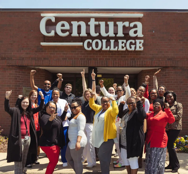 Staff members of Centura College standing in front of the campus building