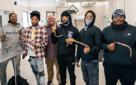 A group of Centura College HVAC students standing together in a classroom