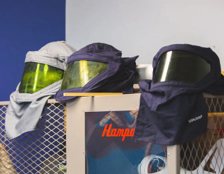 Three welding masks on a shelf