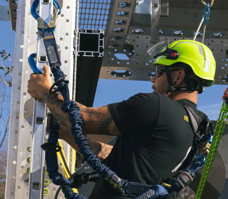 A Centura College wind turbine technician student climbing a wind turbine tower