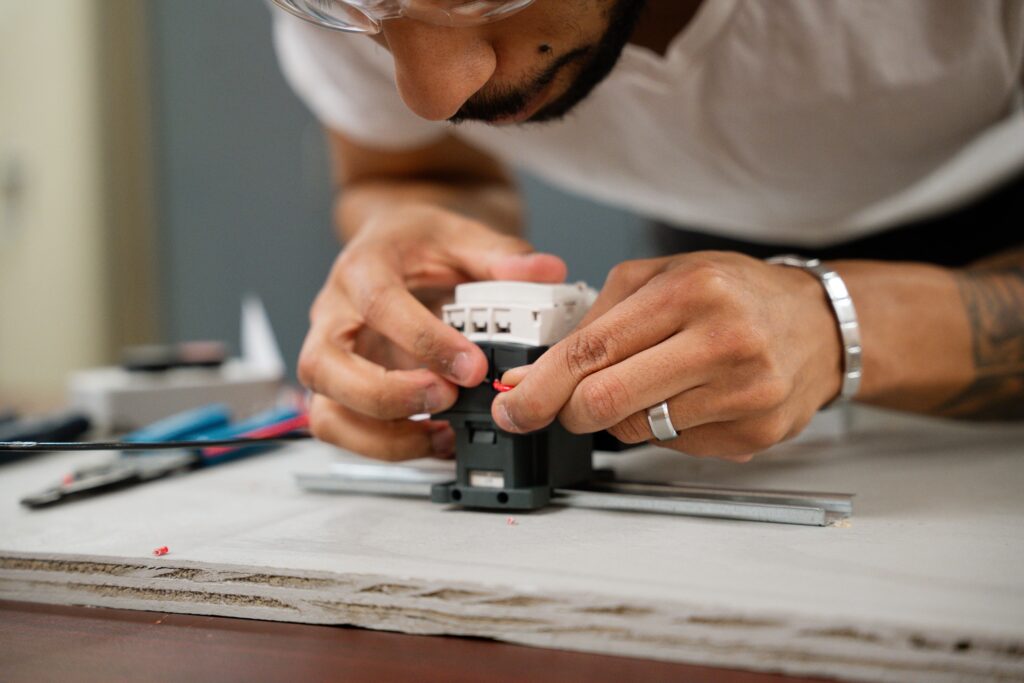 Close-up of a Centura College student working with circuit components as part of the electrical training programs.