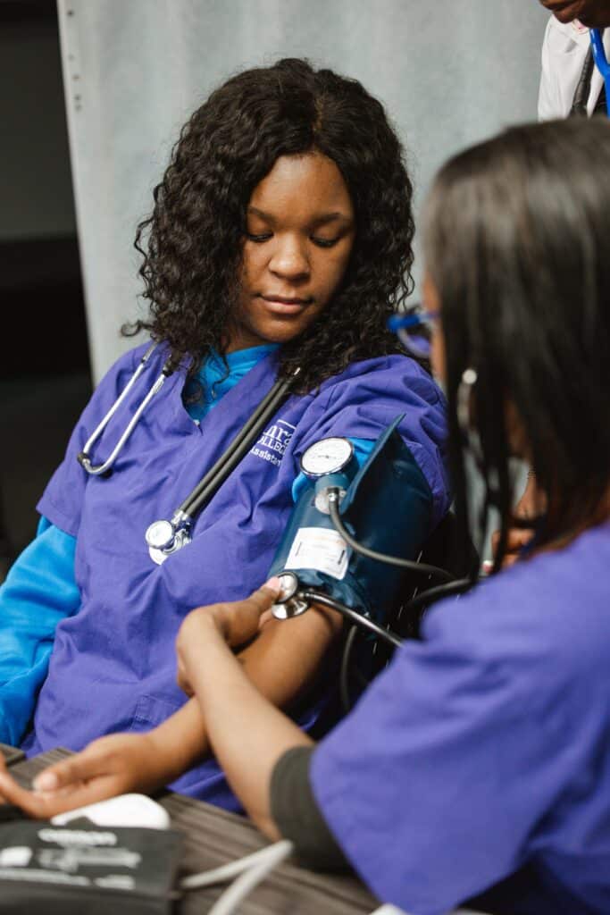 Centura College student practices taking blood pressure during hands-on training, showcasing the value behind the cost of medical assistant program.